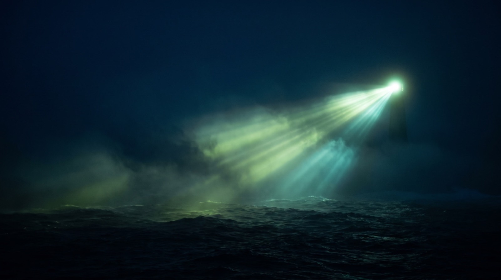 A green-white lighthouse beam sweeping through dark sea mist, representing AI agents guided by trusted data